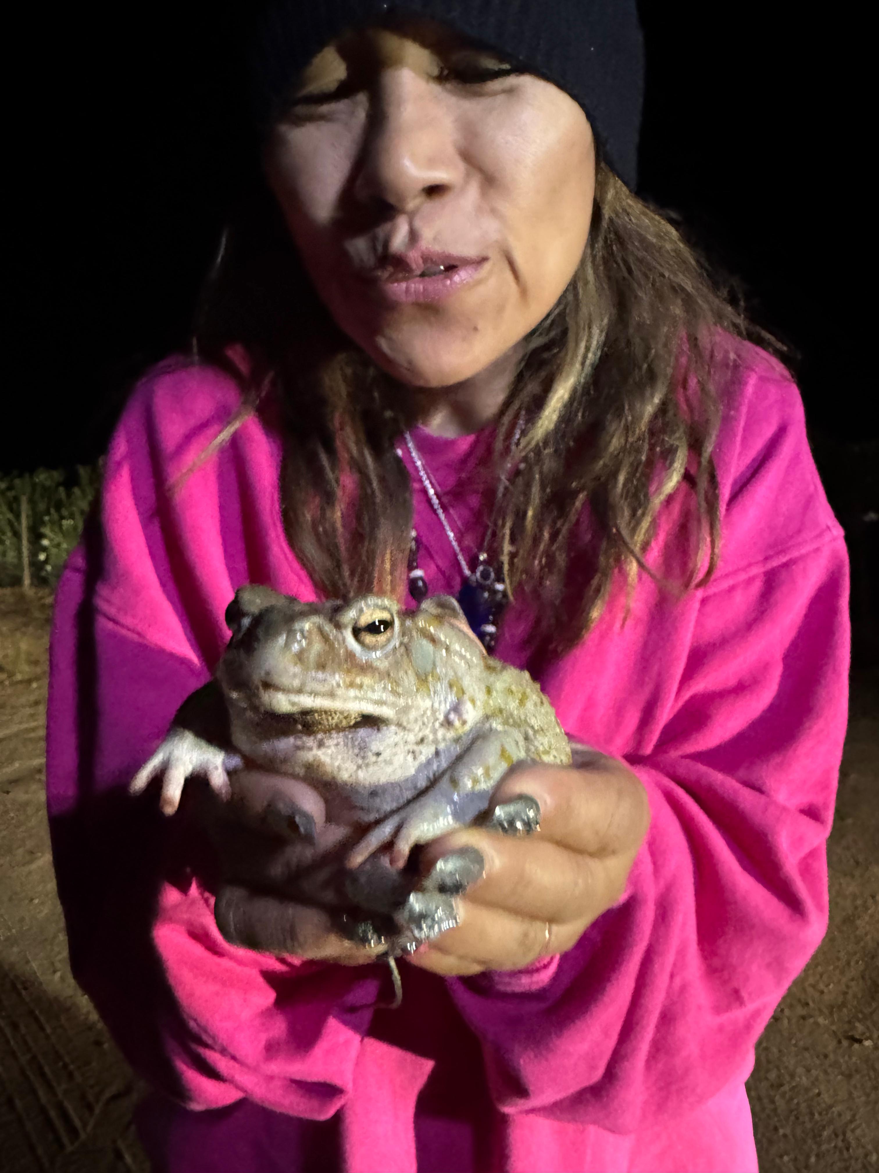 Cradling the toad close
