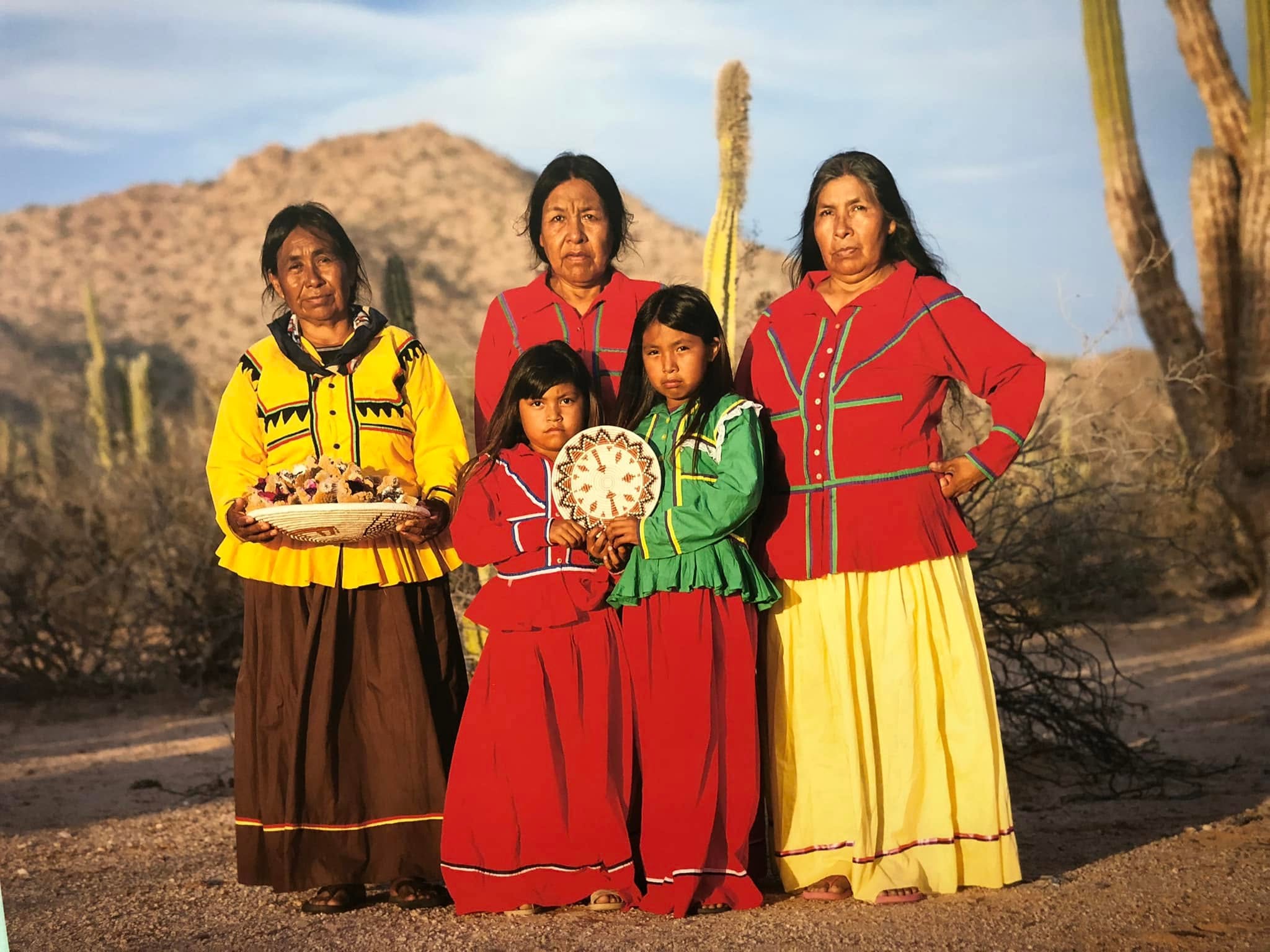 Comcaac women in traditional dress in the Sonoran landscape