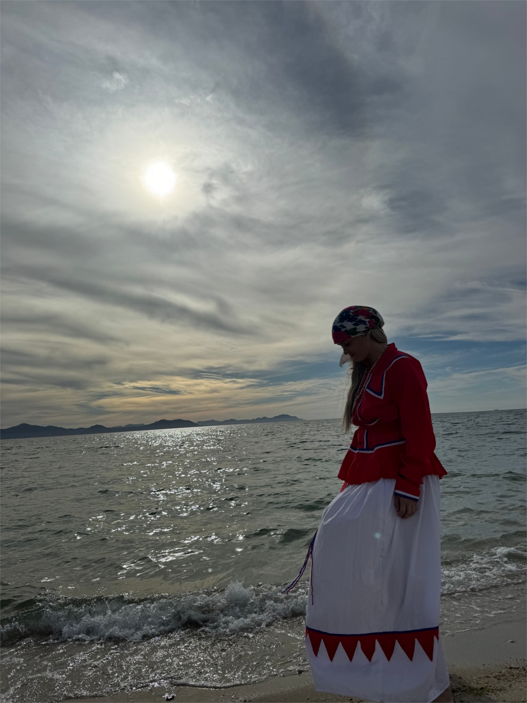 By the water in ceremonial dress